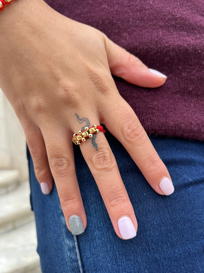 Anillo tejido cruzado balín oro laminado 18k